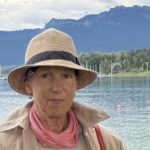 Claudia Beisitzer*in des Grünen Ortsverbands Prien, steht vor dem Chiemsee. Blickt freundlich in die Kamera.